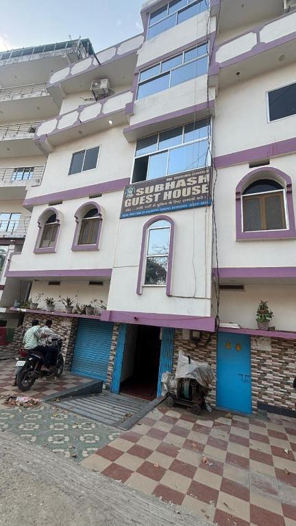 a building with a motorcycle parked in front of it at Subhash Guest House in Gaya