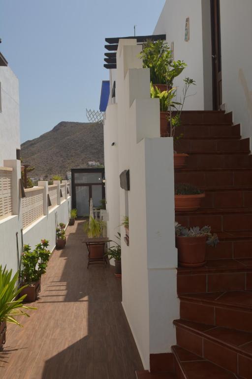 a balcony of a house with potted plants at Habitaciones Martín in San José