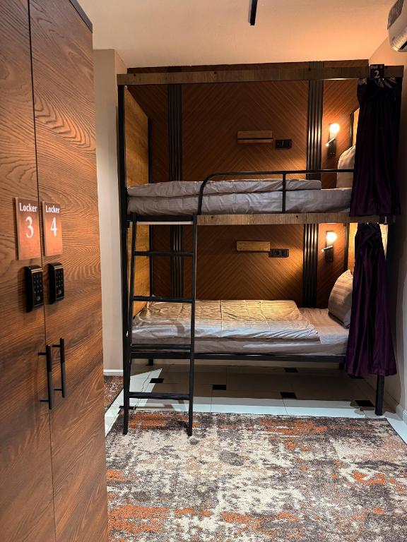 a room with two bunk beds and a door at TWENTY Hostel in Samarkand