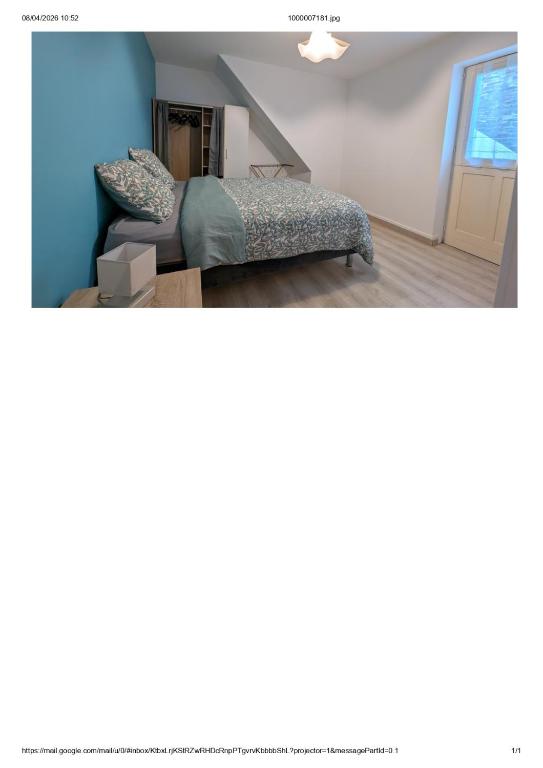 a bedroom with blue walls and a bed in a room at Centre Granville in Granville