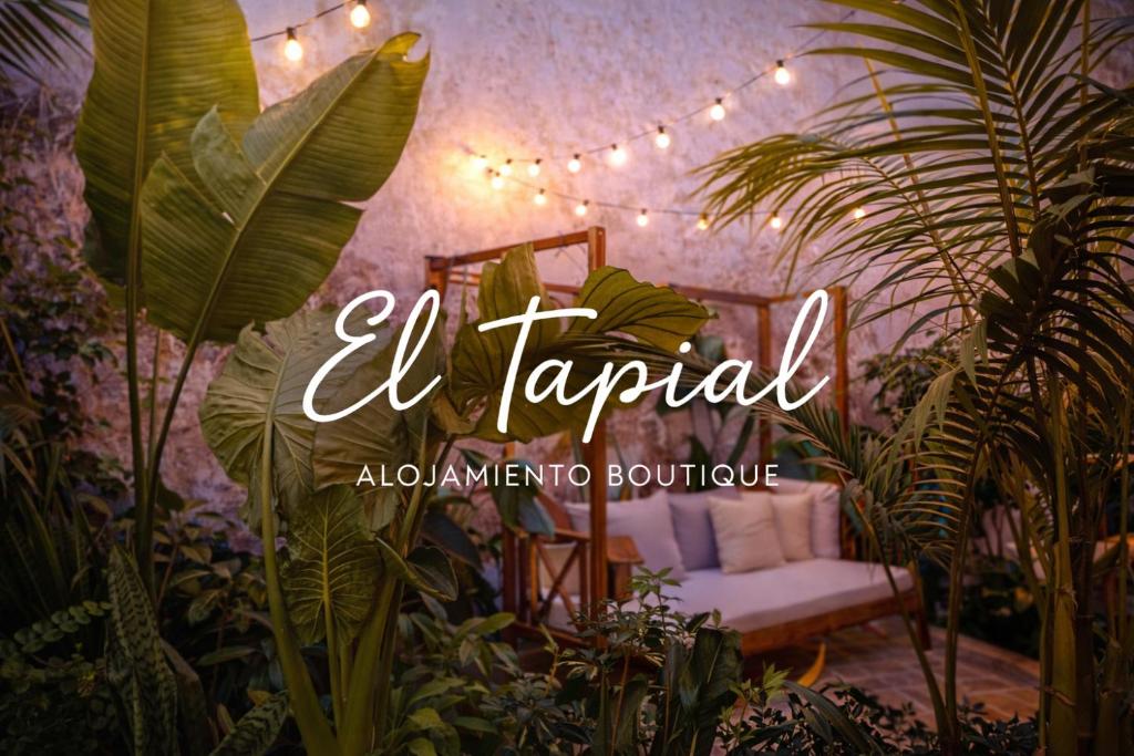 a sign that says la tarpaulin in a room with plants at El Tapial in Chipiona