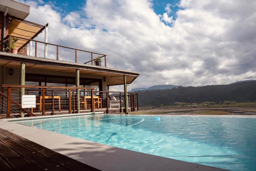 a large swimming pool in front of a building at Interlaken Guest House in Wilderness