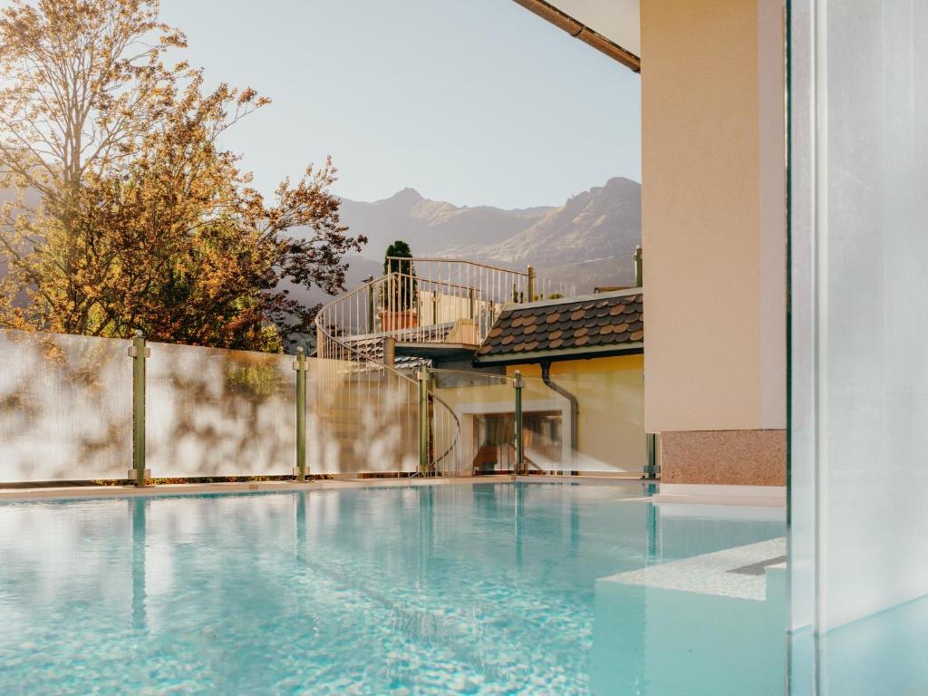 a swimming pool with a view of the mountains at POST POST Hotel - Alpine Boutique Hotel & Spa in Bad Hofgastein
