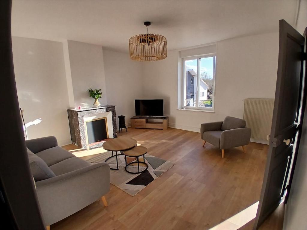 a living room with a couch and a fireplace at 4-person apartment La Salamandre in Gondreville