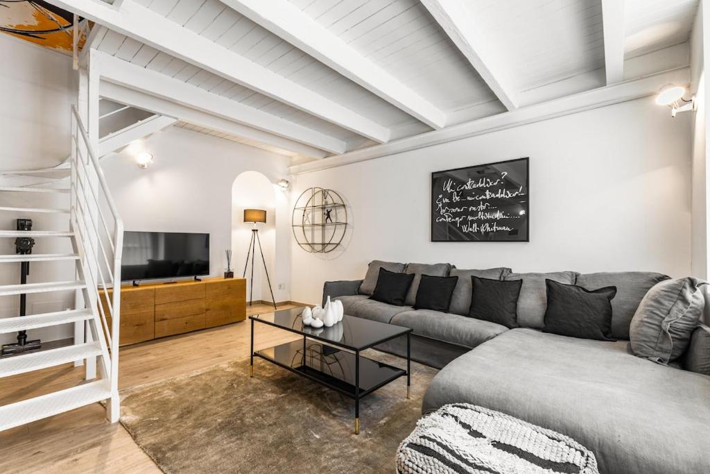 a living room with a couch and a table at Elisabeth s Loft in Milan