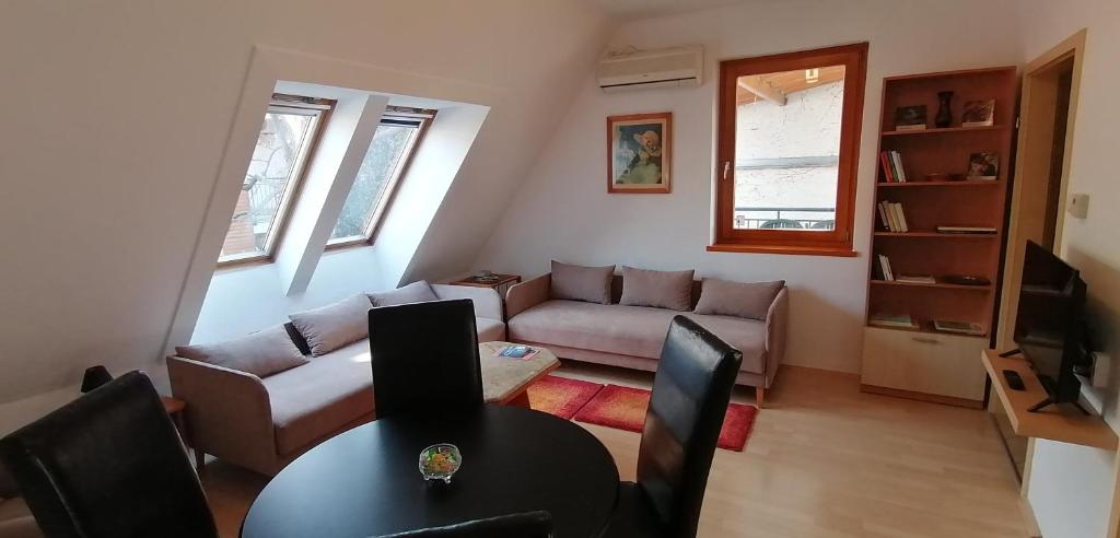 a living room with a couch and a table at Central Pécs Free Parking in Pécs