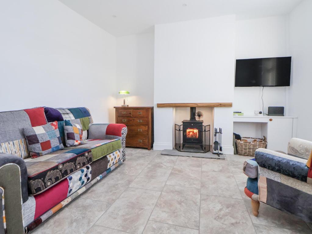 a living room with a couch and a fire place at 10 South Street in Rossendale