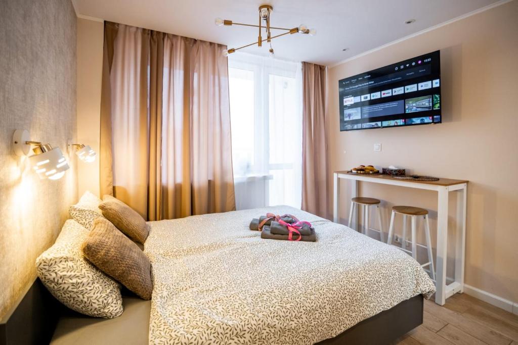 a hotel room with a bed and a bar at Super Central Modern Studio #Palace View #55''Smart TV #Fast Wi-Fi #Metro in Warsaw