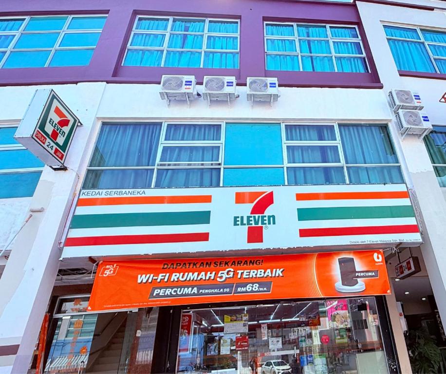 a building with a store front with two chairs in front at New century inn in Bintulu