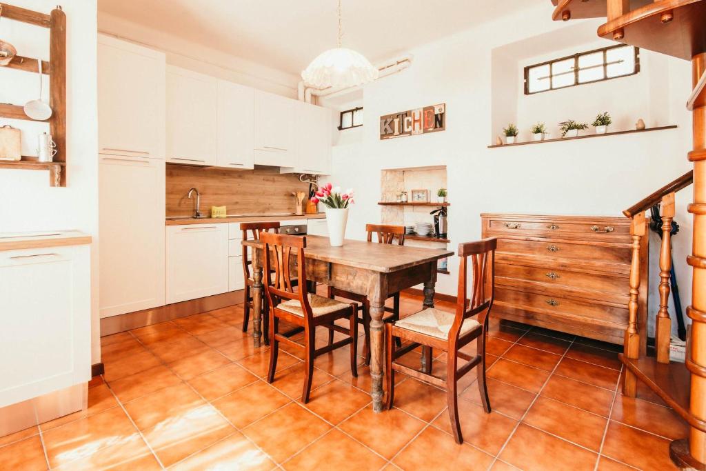 a kitchen with a wooden table and chairs at La casa di Solcio - Lakeside srl L&B in Lesa