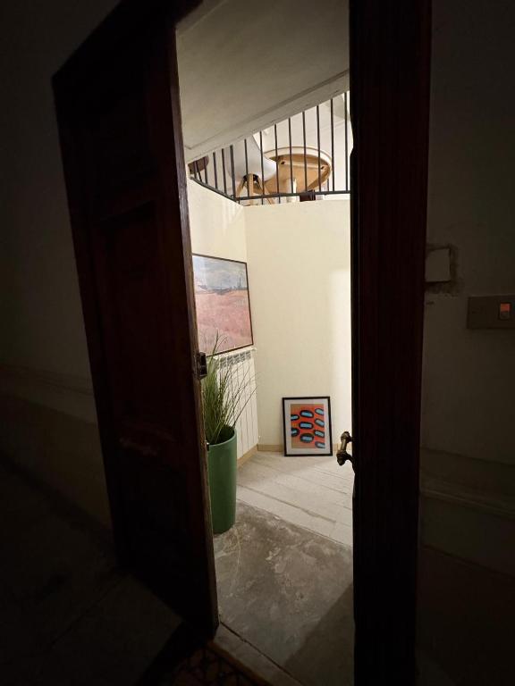 an open door to a room with a potted plant at Palazzo Bosco in Cosenza