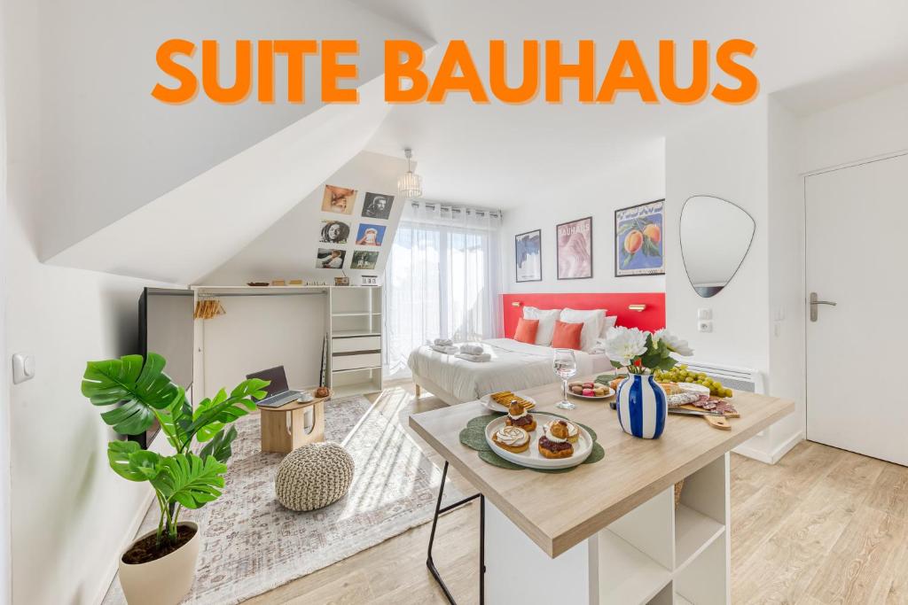 a living room with a table with food on it at Suite Bauhaus - Proche Paris - Terrasse - Netflix in Bobigny