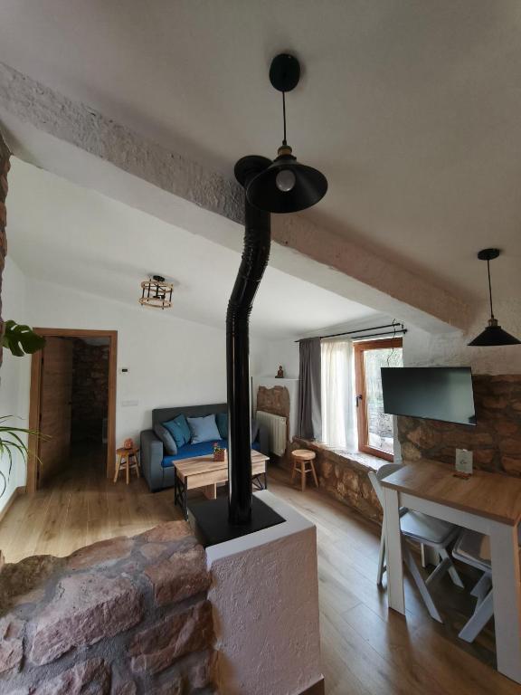 a living room with a wood stove in it at Mas Lloretó - El Rossinyol in Copóns
