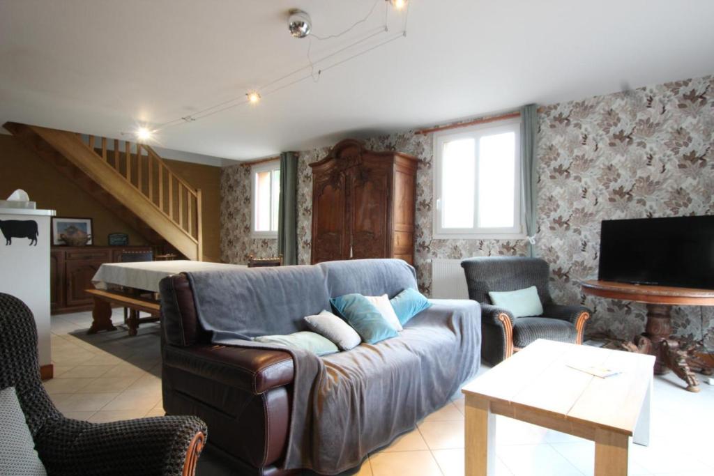 a living room with a couch and a bed at Gîte G40 in Marchésieux