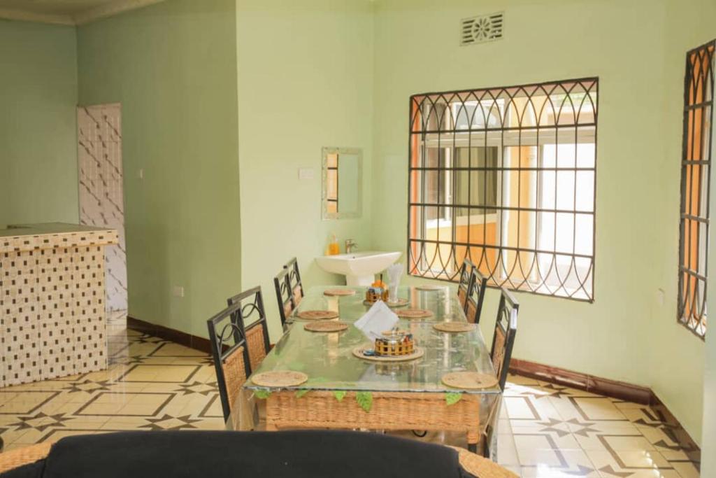 a room with a table with chairs and a sink at Newfavourlodge in Nkoanrua