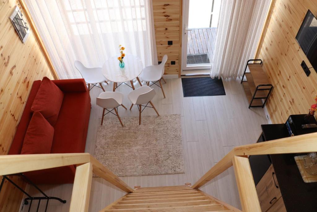 a room with a table and chairs in a tiny house at Barn Peaks Karakol in Karakol