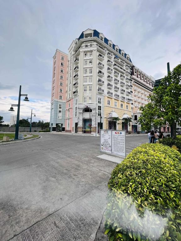 a large building with a sign in front of it at Saint Honore - La Casa De Khea in Sampong