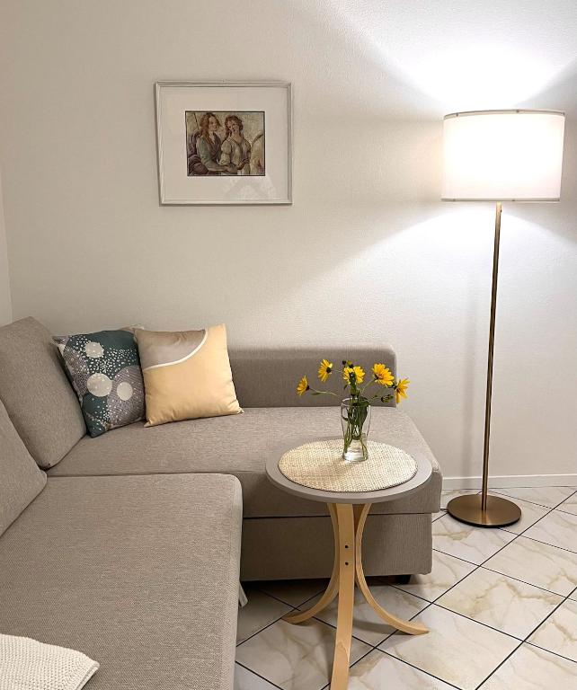 a living room with a couch and a table at Spacious, renovated apartment in the centre in Montecatini Terme