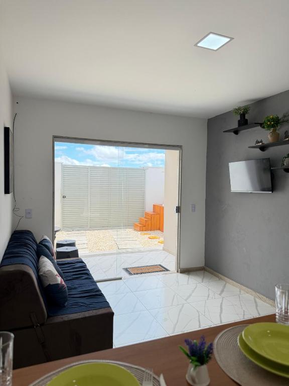 a living room with a couch and a table at Casa Privativa Jacuzzi em Linhares in Linhares