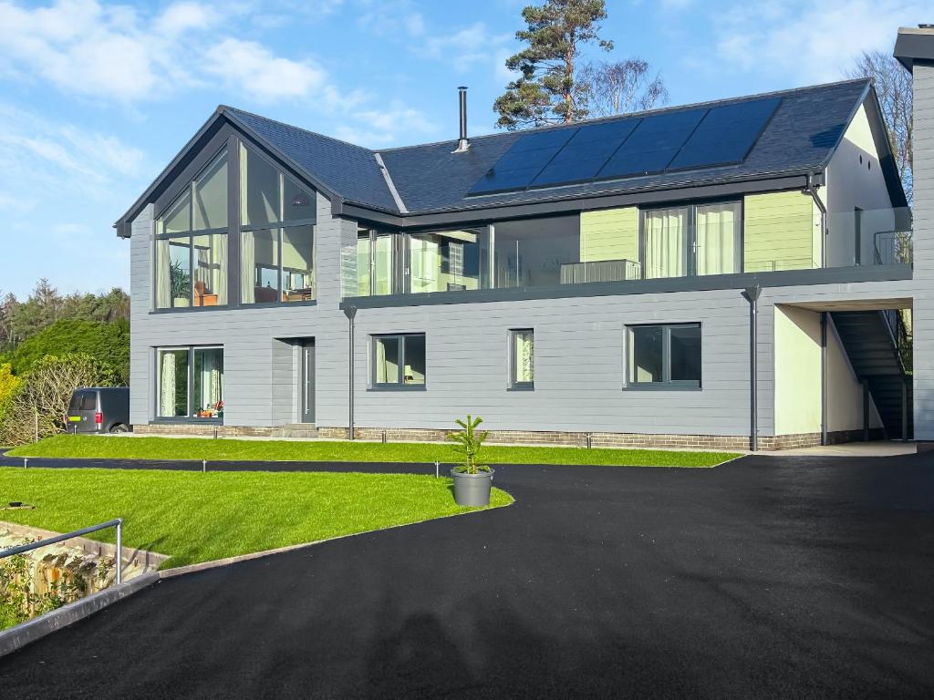 a house with solar panels on top of it at Grey Rocks House in Kippford