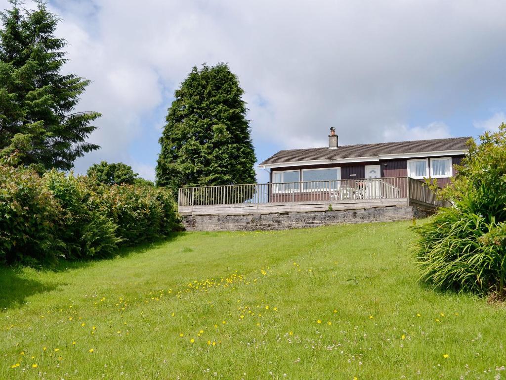 a house with a large yard in front of it at Carnethy in Tighnabruaich
