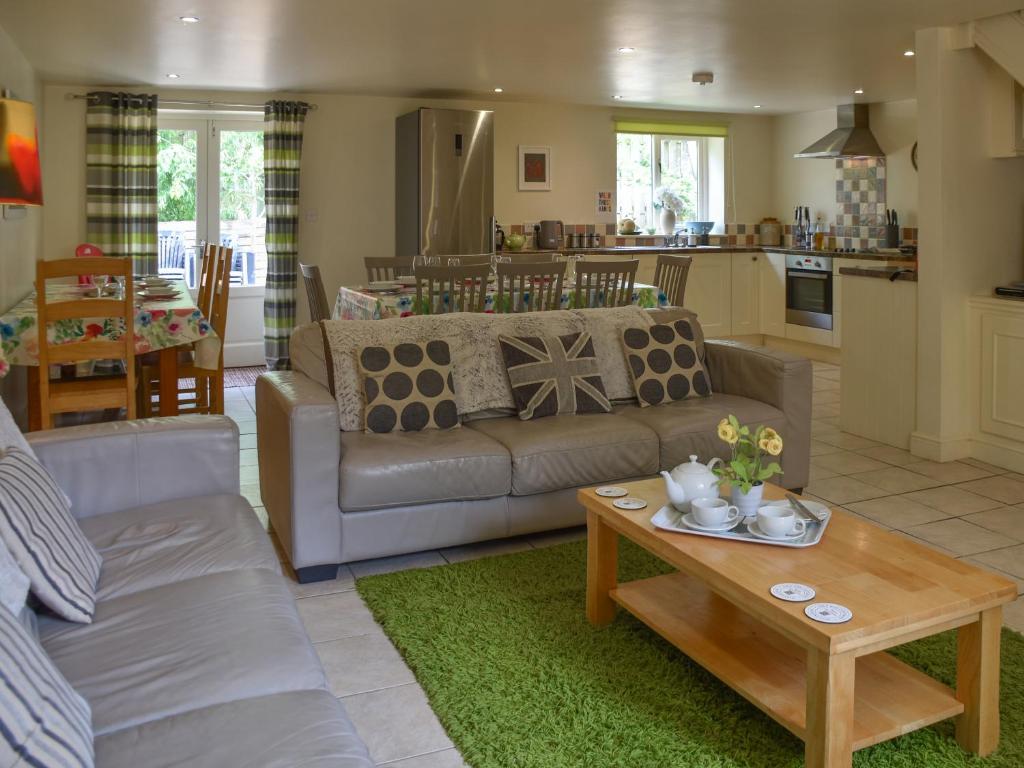 a living room with a couch and a table at Lily Pad 7 - Uk43916 in Nassington