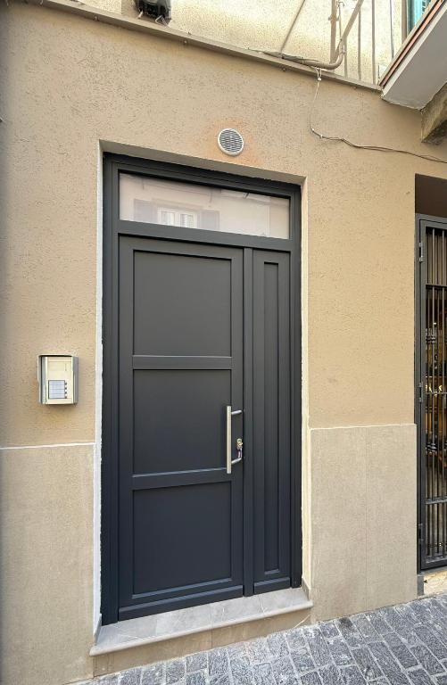 a black door on the side of a building at Chiara 2 in Cairo Montenotte