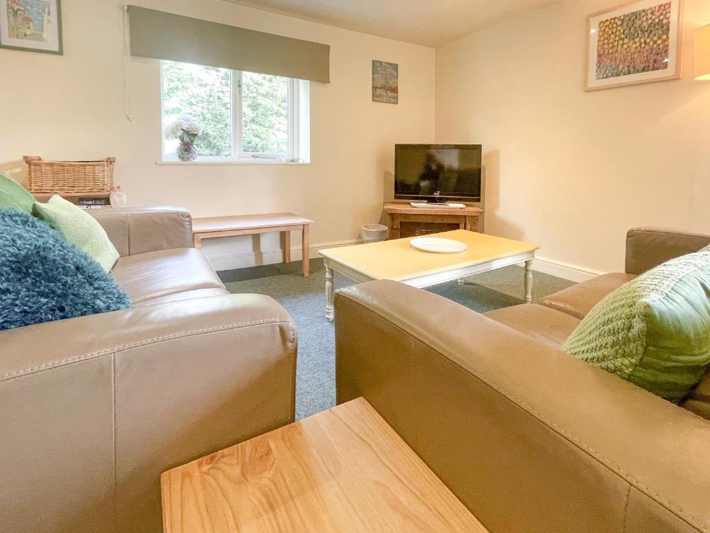 a living room with two couches and a tv at Lily Pad 9 - Uk43919 in Nassington