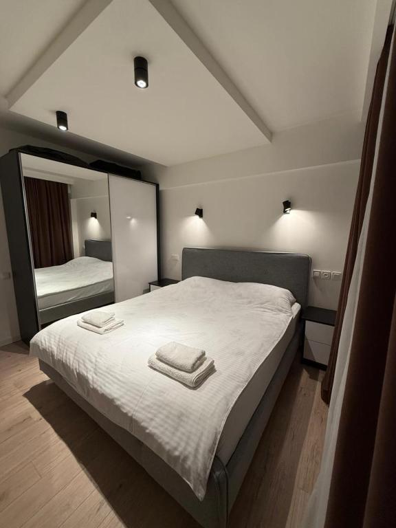 a bedroom with a large bed with two towels on it at Cozy Newly Renovated Apartment in Batumi Old Town in Batumi