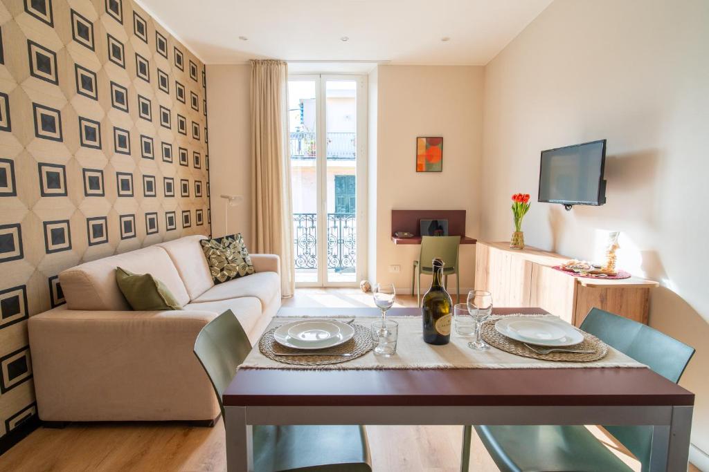 a living room with a couch and a table at Sul Corso Sanremo in Sanremo
