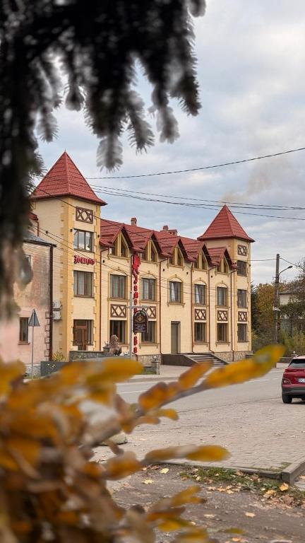 a large tan building with red roof at Відпочинковий - комплекс '"Замок Лева"" in Peremyshlyany