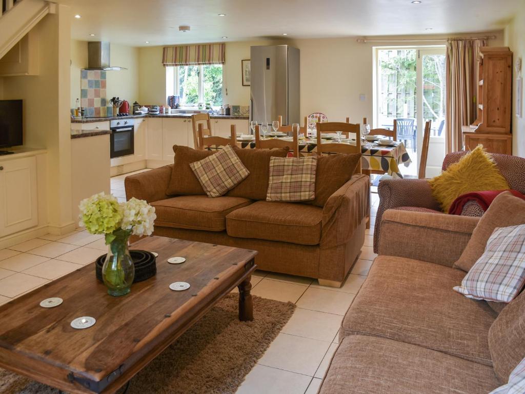 a living room with couches and a table at Lily Pad 6 - Uk43915 in Nassington