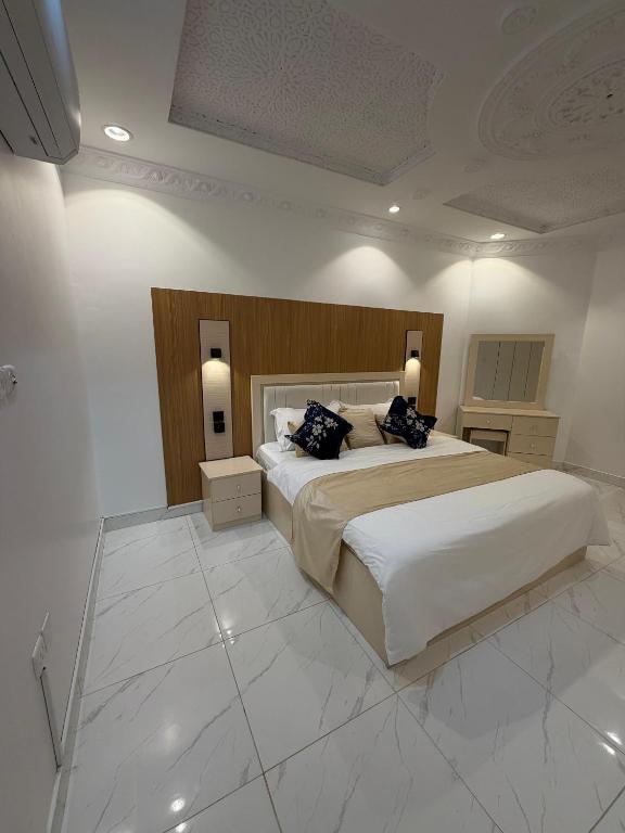 a large bedroom with a large bed with two pillows at رفاه الماسي in Medina