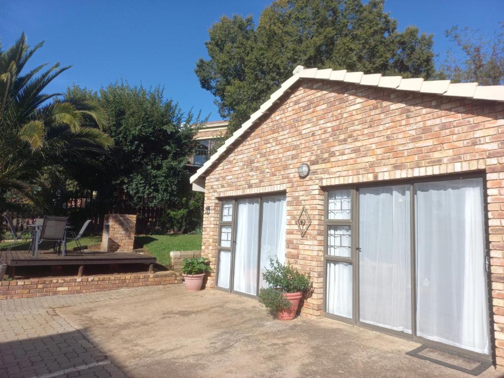 a brick building with two garage doors at Forever Clarens in Clarens