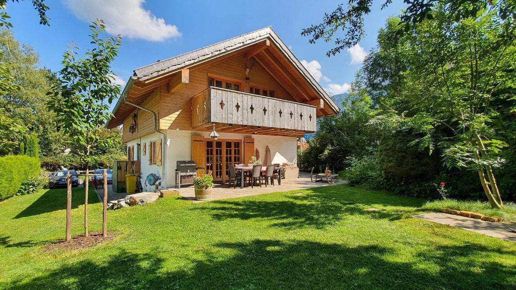 a wooden house with a porch and a yard at Kienberghäusle in Pfronten