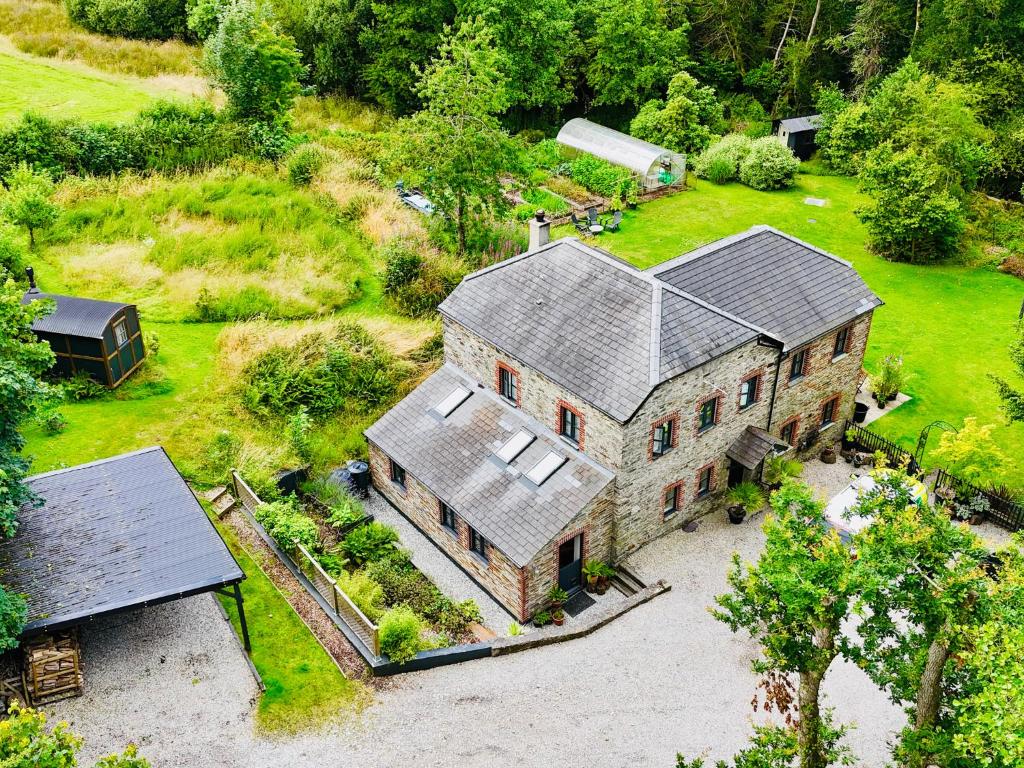 an aerial view of a large house with a barn at The Leat at The Old Mill in Tavistock