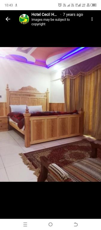 a picture of a bedroom with two large beds at Cecil homes hotel in Murree