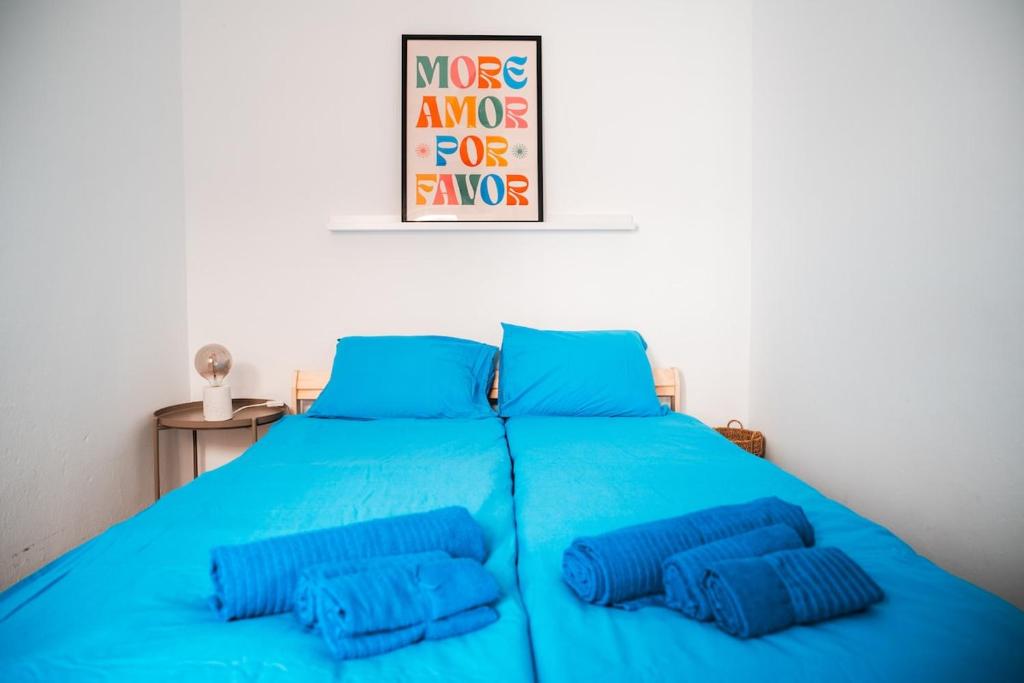 a blue bed with two blue pillows on it at Blue Bay in Lagos