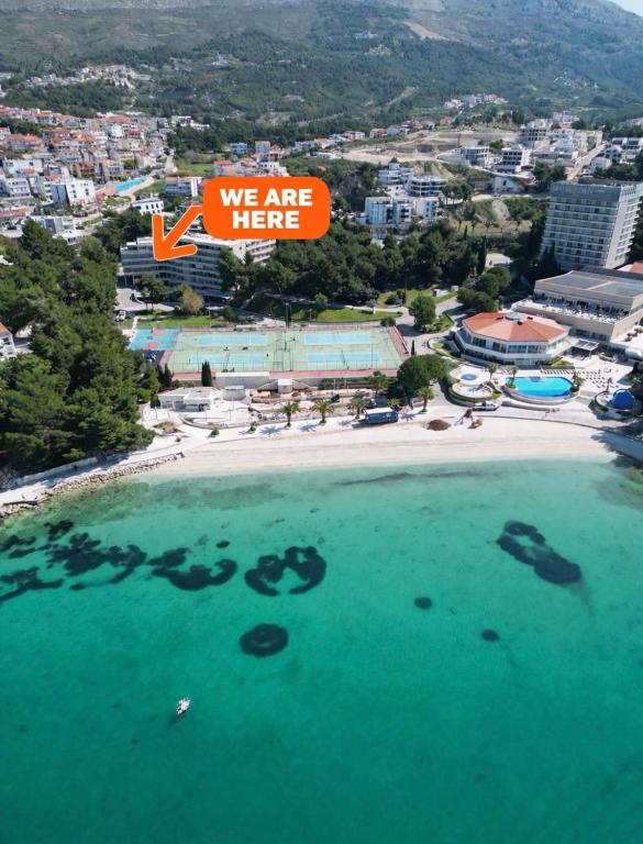 an aerial view of a beach with a sign that says we are here at Darkin 10 in Strožanac