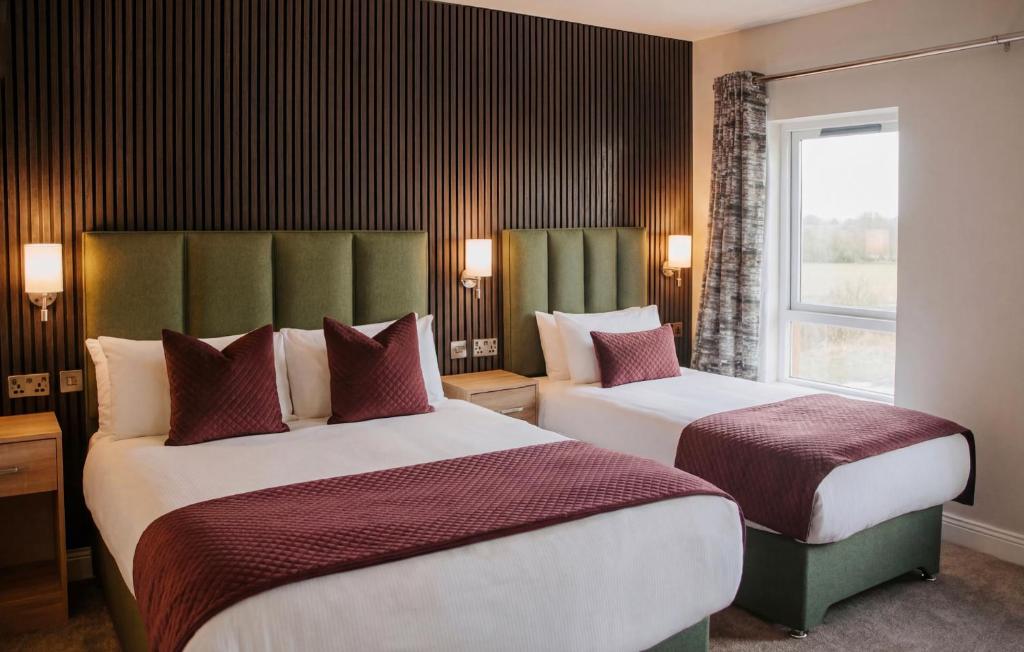 a hotel room with two beds and a window at Kerry Coast Hotel in Cahersiveen