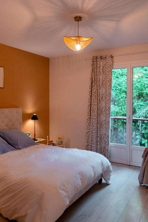 a bedroom with a white bed and a window at Charming apartment in Porto-Vecchio in Porto-Vecchio