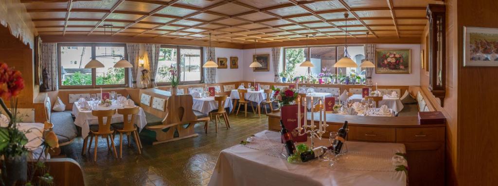 un ristorante con tavoli e sedie in una stanza di Hotel Helga a Seefeld in Tirol
