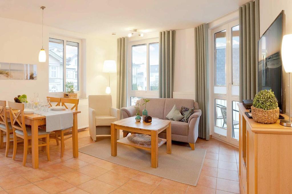 a living room with a table and a dining room at FeWo Auszeit in Ahlbeck