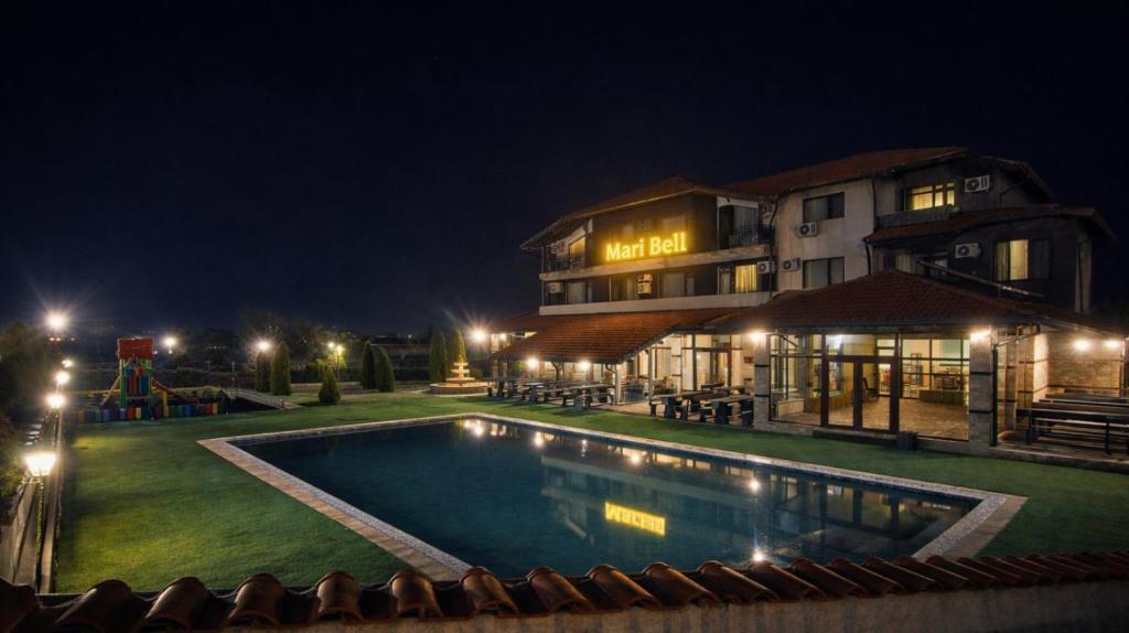 a hotel with a swimming pool at night at Maribel Spa Hotel in Köprilova