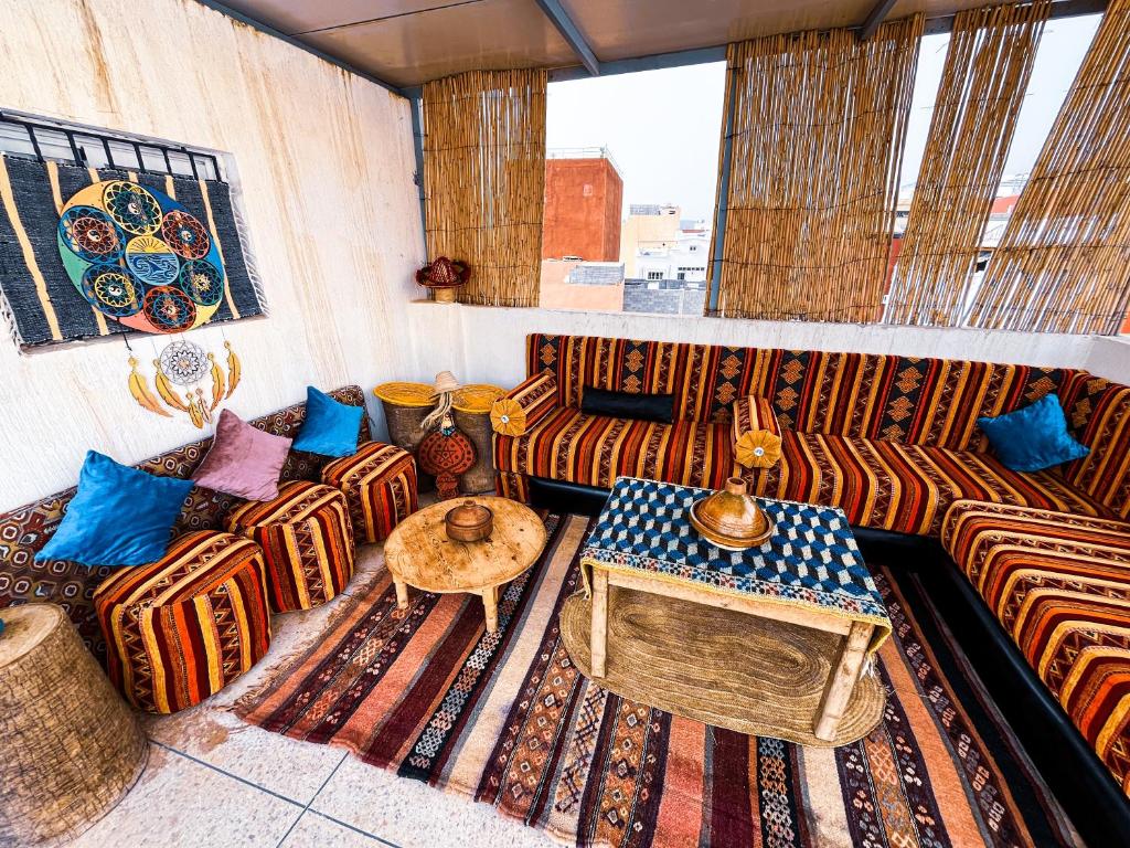 a living room with couches and a table at Itrane Hostel in Tamraght Ouzdar