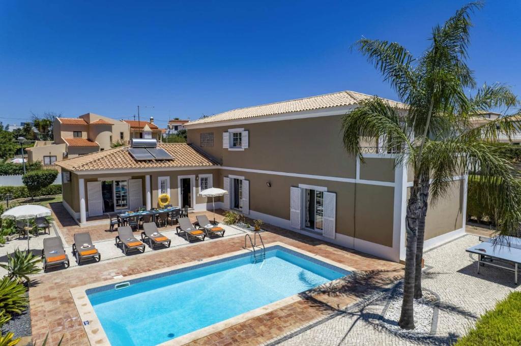 a villa with a swimming pool and a house at Villa Teotel by Villa Plus in Almancil
