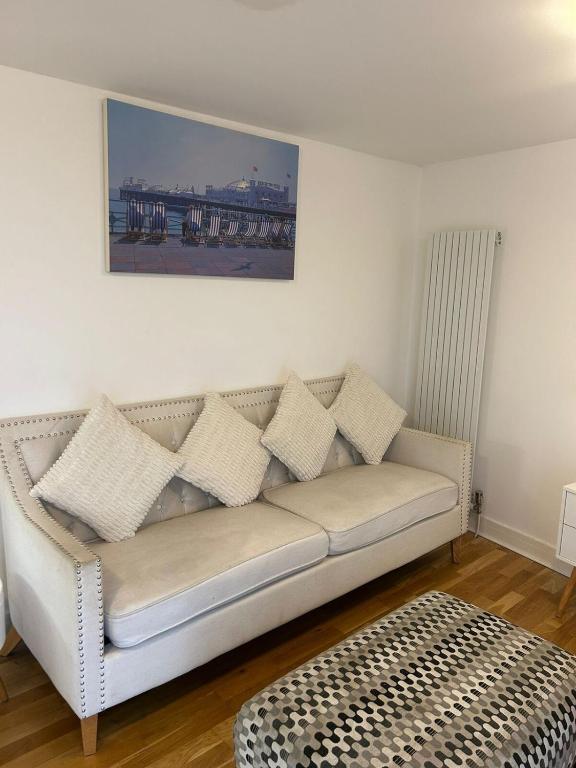 a living room with a couch with pillows on it at A beautiful 2-bedroom Apartment in Skegness