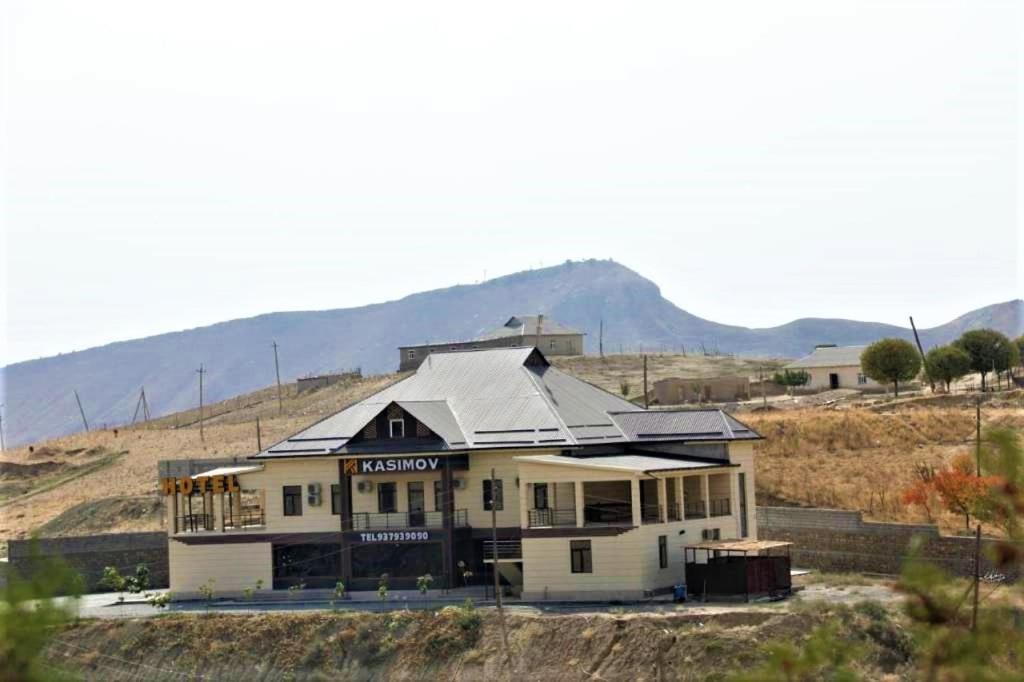 a large house in the middle of a field at Hotel KASIMOV in Podan