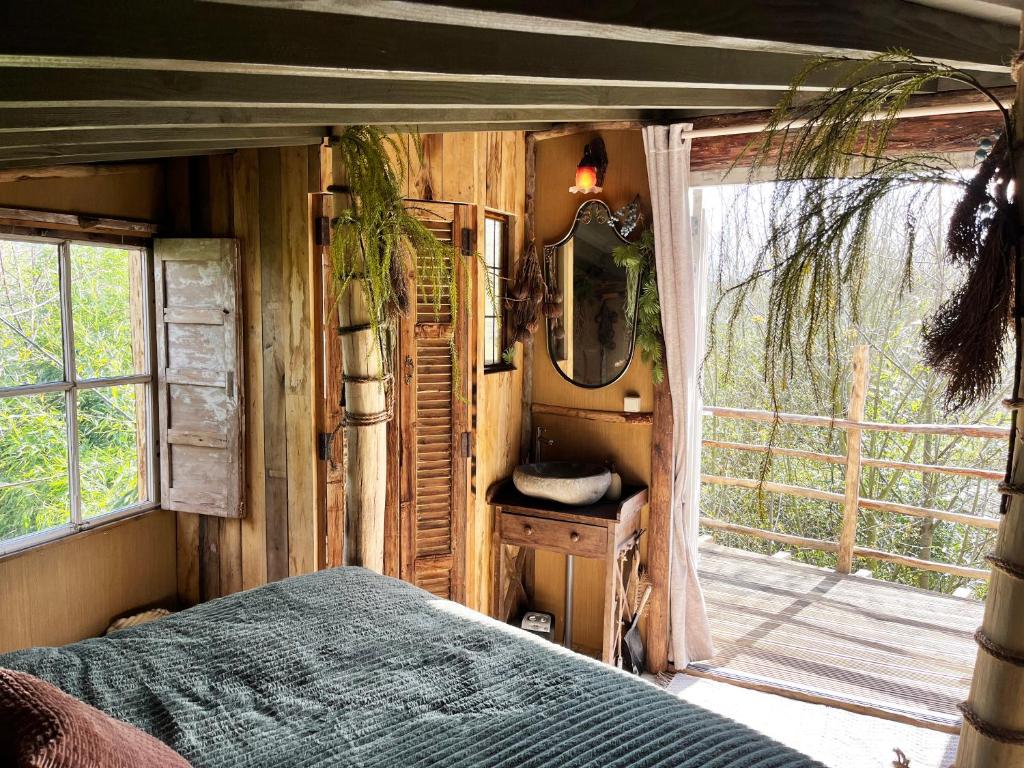 a bedroom with a bed and a mirror and a window at Bamboo Lodge Groningen in Groningen