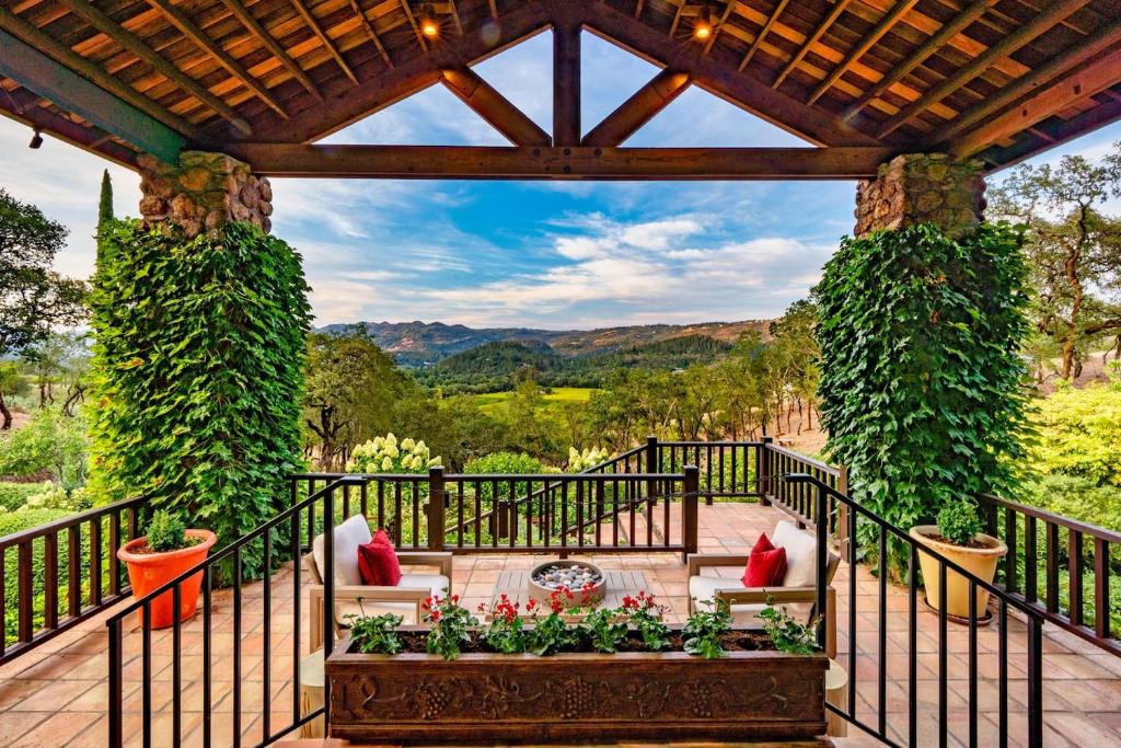 a pergola with a couch on a patio at Morlet Hilltop House in St. Helena